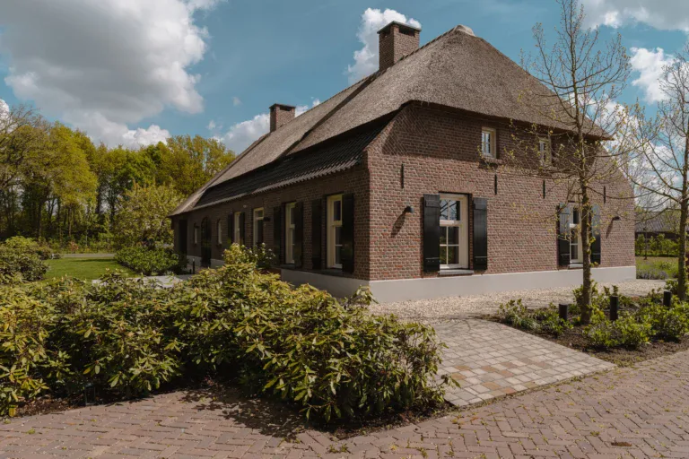 Hedendaagse langgevelboerderij met rieten dak en houten kozijnen in Someren